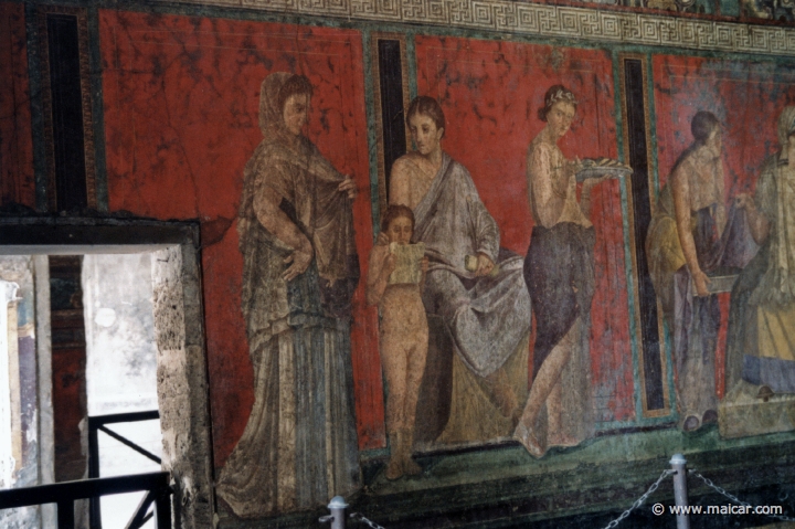 7417.jpg - 7417: Villa dei Misteri, Pompeii. From left to right: Young Dionysus reads the ritual of the initiate; the woman initiator watches and holds a ‘volumen’ in her left hand; the young woman making the offering approaches the priestess. Pompeii.