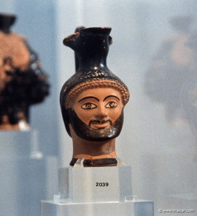 6204.jpg - 6204: Small vases for perfumed oils in the shape of an Aethiop’s, a kore’s or Herakles’ head from a particular production of Attic workshops at the end of the 6C BC. National Archaeological Museum, Athens.