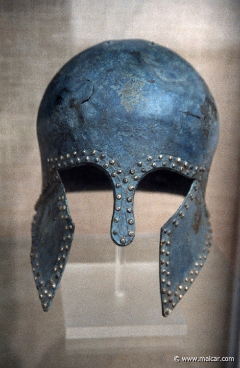6727.jpg - 6727: Corinthian bronze helmet. Middle of 7th century BC. Archaeological Museum, Olympia.