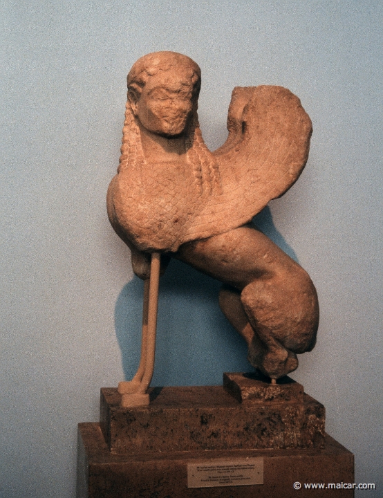 6128.jpg - 6128: Sphinx. Parian marble. Found on Peiraieus. It originally crowned a grave stele. About 540 BC. National Archaeological Museum, Athens.