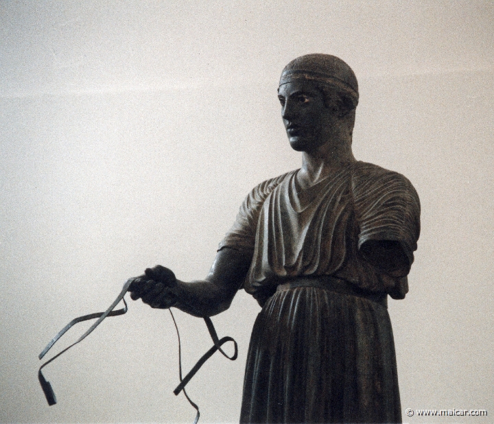 6035.jpg - 6035: Bronze statue of a charioteer belonging to a quadriga. Dedication of the Syracusean Polyzalos, brother of the tyrants Gelo and Hiero. Masterpiece of an unknown artist (about 478 BC). Archaeological Museum, Delphi.