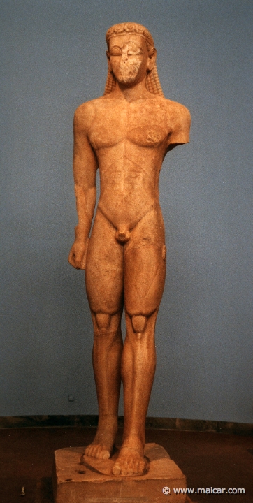 6125.jpg - 6125: Statue of a Kouros. Naxian marble. Found in Sounion. The statue was a votive offering to Poseidon and stood before his temple. About 600 BC. National Archaeological Museum, Athens.
