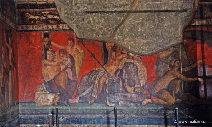 7415.jpg - Villa dei Misteri, Pompeii. From left to right: Silenus giving a drink to a young Satyr, while another Satyr holds up a frightening mask; Dionysus sits with Ariadne; initiates. Pompeii.