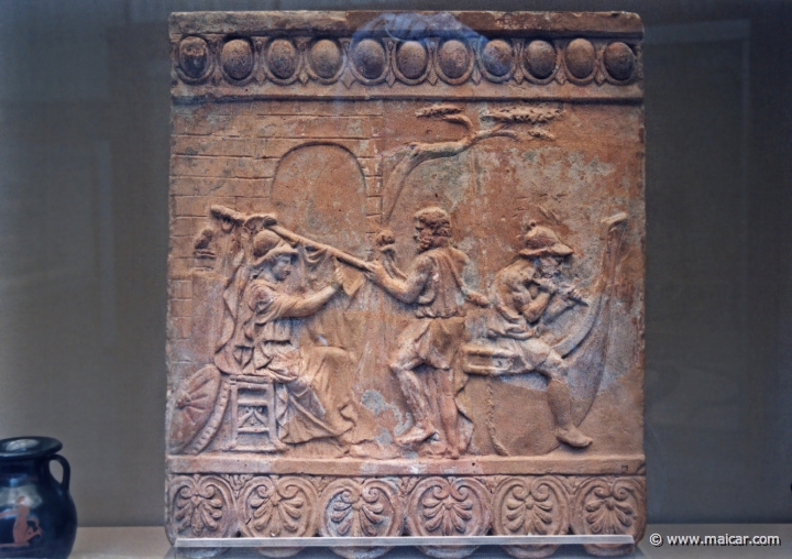 8036.jpg - 8036: Terracotta relief. Athena supervises the building of the ship Argo, c. 1st century AD. The yard is held by the helmsman Tiphys, Argos sits across the stern. British Museum, London.