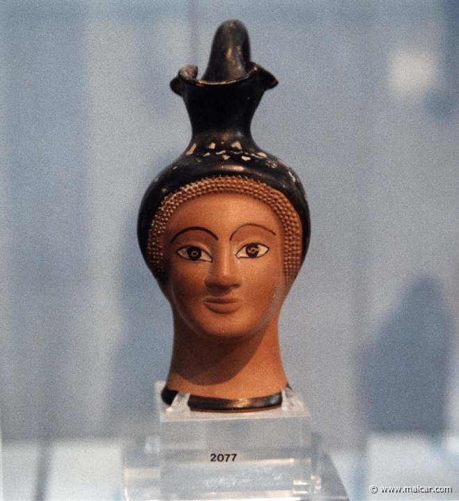 6205.jpg - 6205: Small vases for perfumed oils in the shape of an Aethiop’s, a kore’s or Herakles’ head from a particular production of Attic workshops at the end of the 6C BC. National Archaeological Museum, Athens.