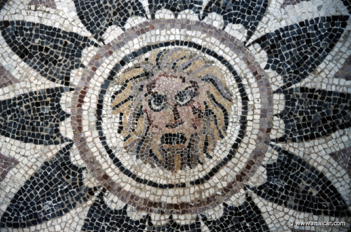 8205.jpg - 8205: Mask of Phobos (fear) within a radiating petal design. 4th century AD. From Halicarnassus. British Museum, London.